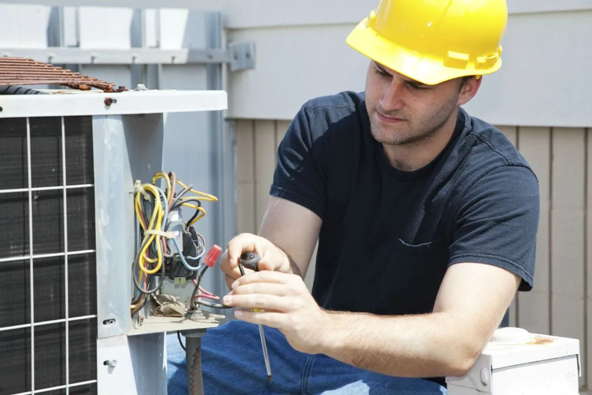 Electrician wiring an outdoor electrical device